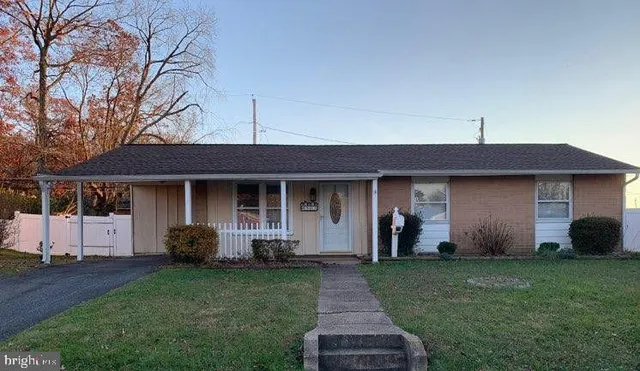 a front view of a house with a garden and plants
