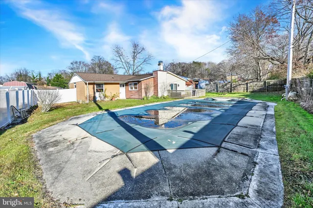 swimming pool view with a seating space