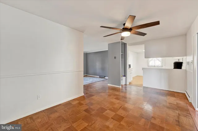 a view of empty room with wooden floor