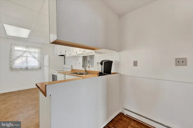 a view of a kitchen with a sink and a cabinet