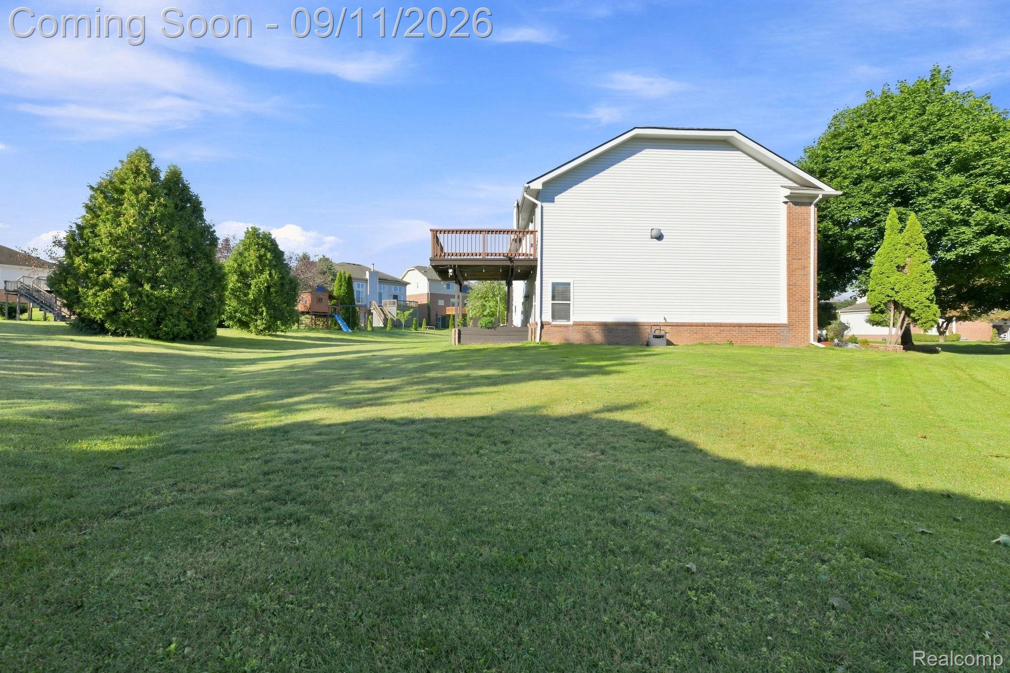 3201 Lynhurst Court Rochester, MI 48306 - Photo 38 of 43 Expansive grass yard with mature evergreen trees and a multi-level wood deck