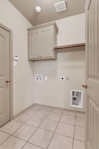 a bedroom with a bed dresser and a flat tv screen