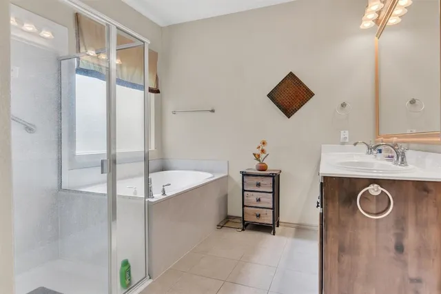 a bathroom with a sink a mirror and a shower