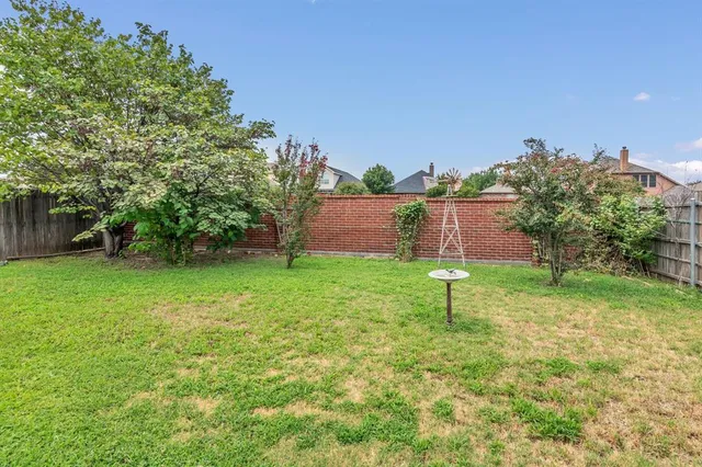 a view of green field with house in the background