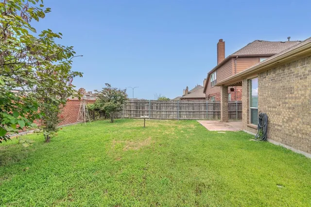 a view of a house with a yard and sitting area