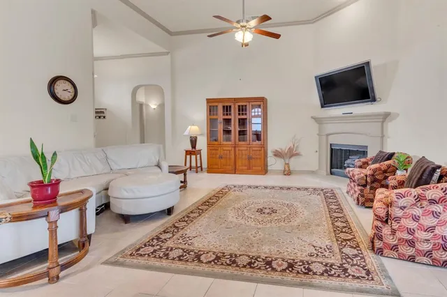 a living room with furniture a fireplace and a flat screen tv
