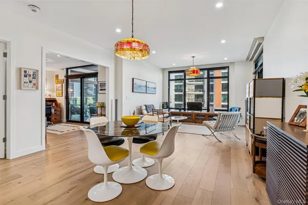 a very nice looking dining room with furniture window and wooden floor