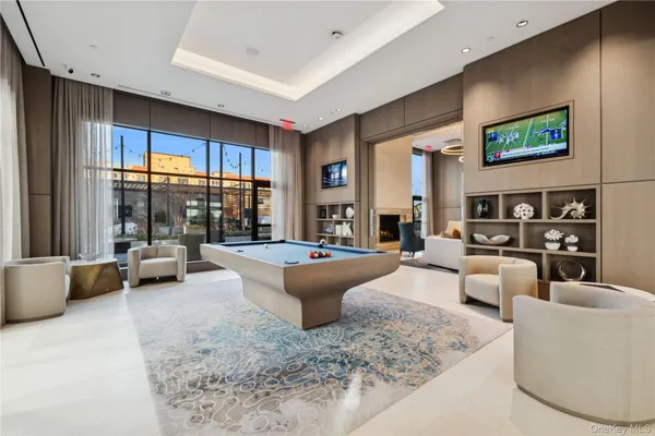 a room with stainless steel appliances kitchen island granite countertop furniture and a dining table