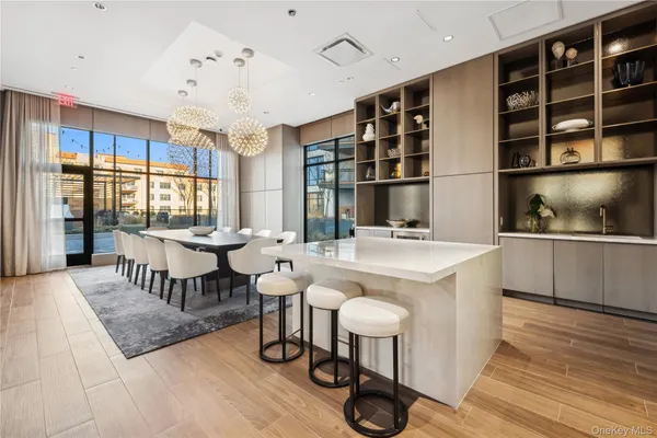 a living room with furniture and a view of kitchen