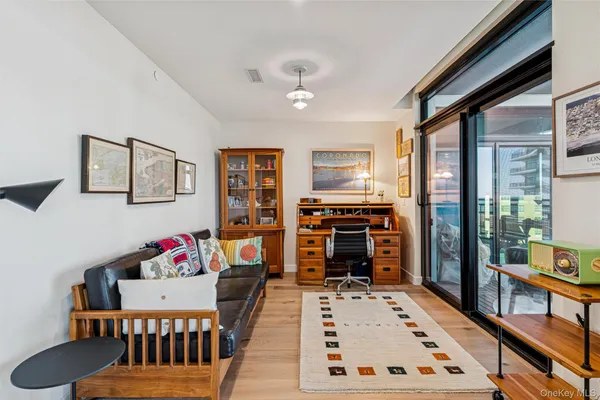 a living room with furniture a flat screen tv and a dining table