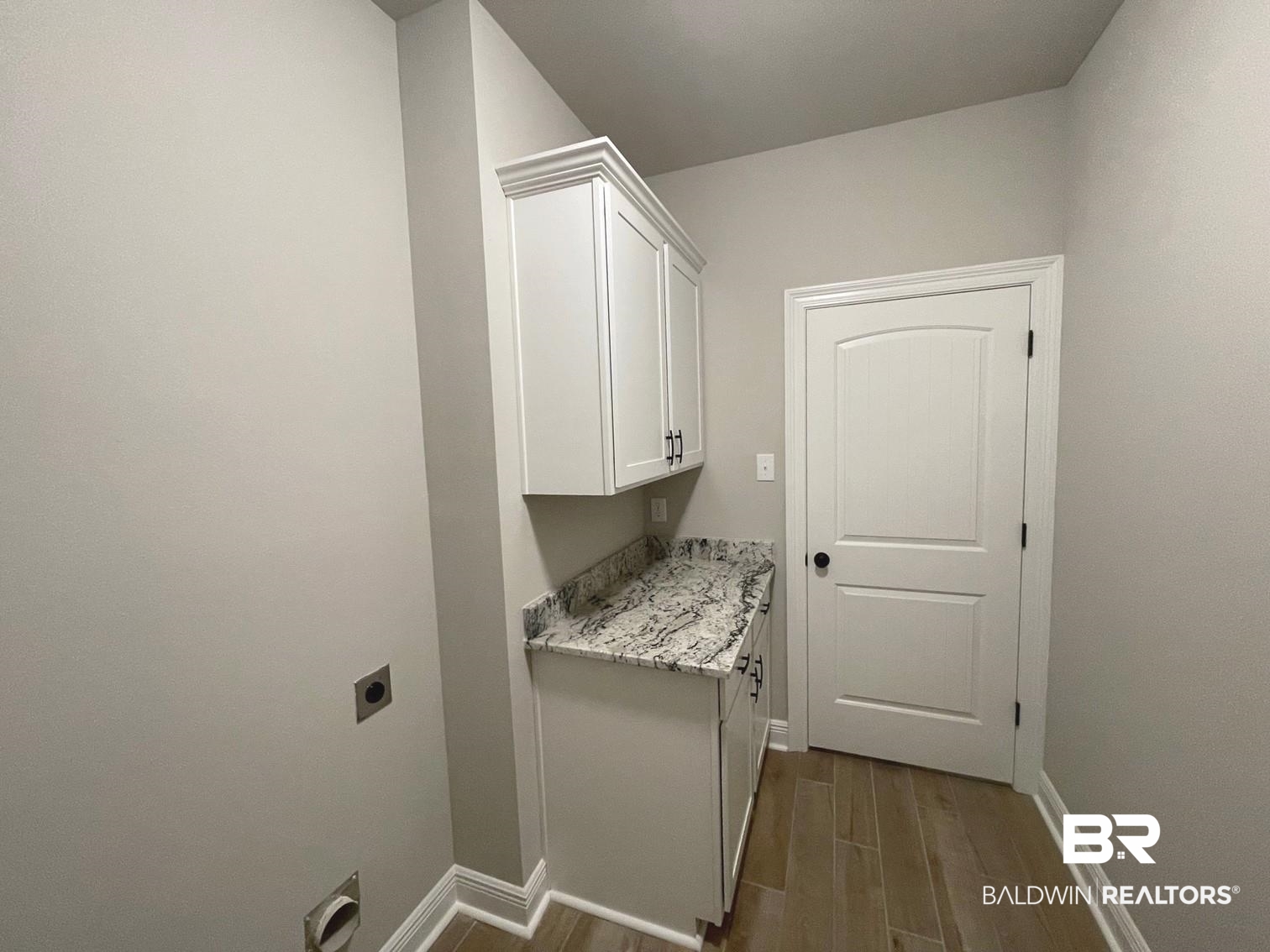 1412 Fenton Circle Foley, AL 36535 - Photo 12 of 15 Laundry room with hookup for an electric dryer, wood-type flooring, and cabinets