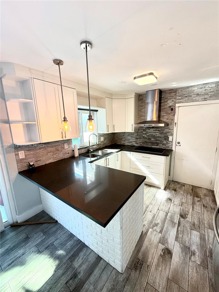 Fairway Estates Miami, FL 33157 - Photo 11 of 34 a kitchen with stainless steel appliances granite countertop a sink a stove and a wooden floor