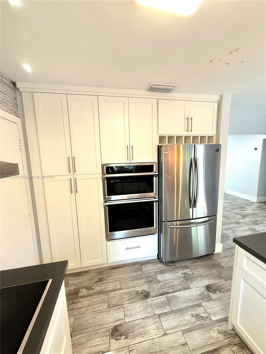 Fairway Estates Miami, FL 33157 - Photo 12 of 34 a kitchen with granite countertop a refrigerator and a stove top oven