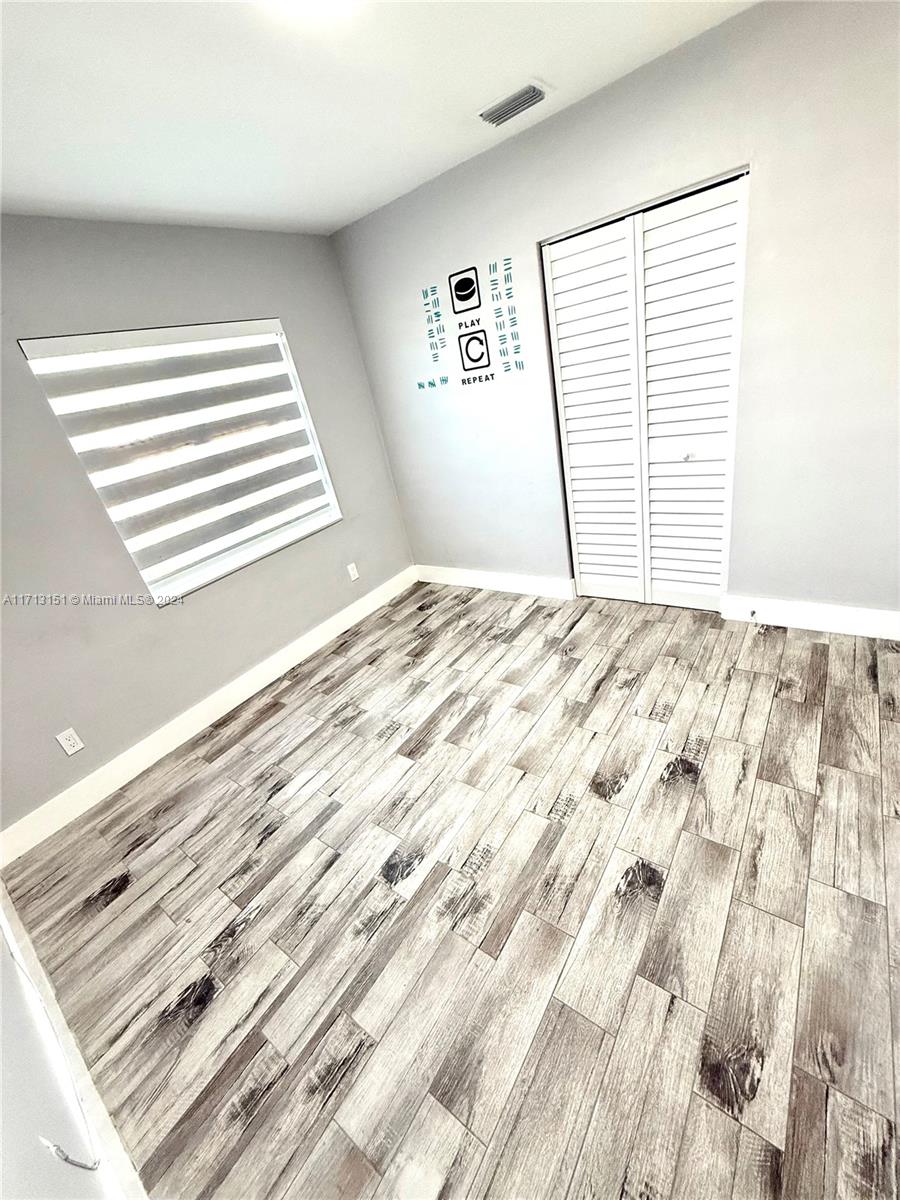 Fairway Estates Miami, FL 33157 - Photo 20 of 34 a view of a bedroom with wooden floor and a window