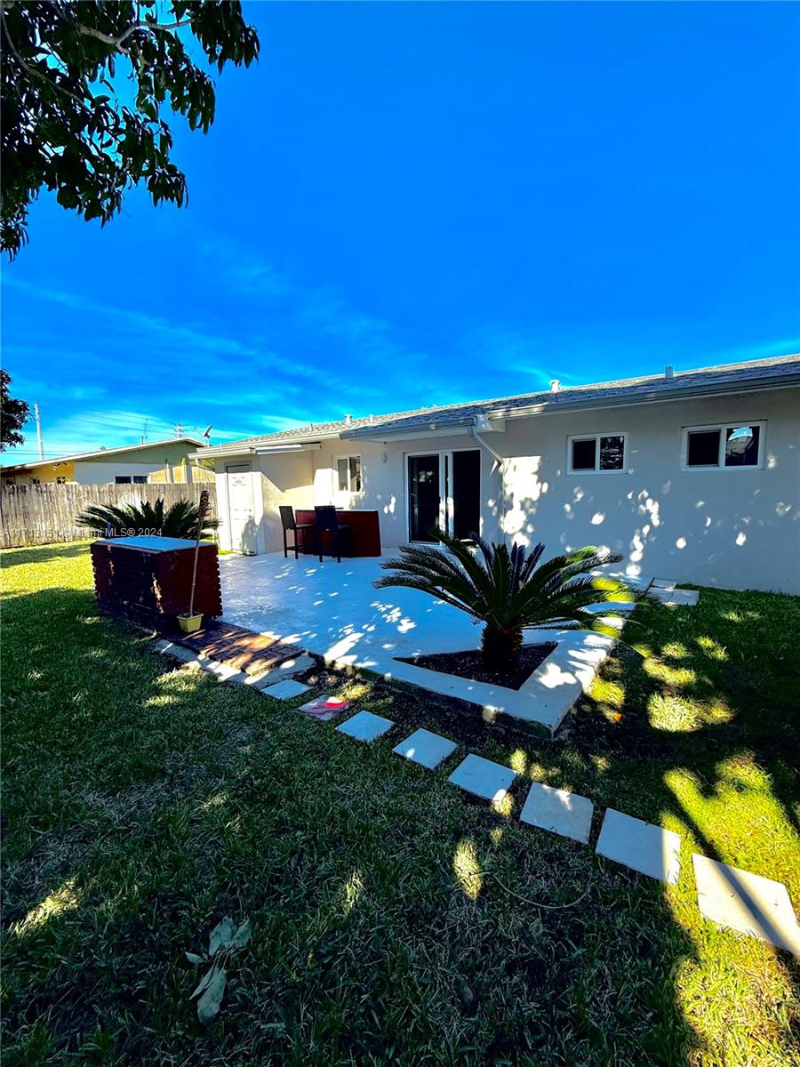 Fairway Estates Miami, FL 33157 - Photo 25 of 34 a view of a patio with table and chairs potted plants and large tree