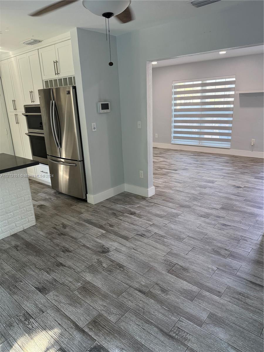 Fairway Estates Miami, FL 33157 - Photo 9 of 34 a view of a refrigerator in kitchen and wooden floor