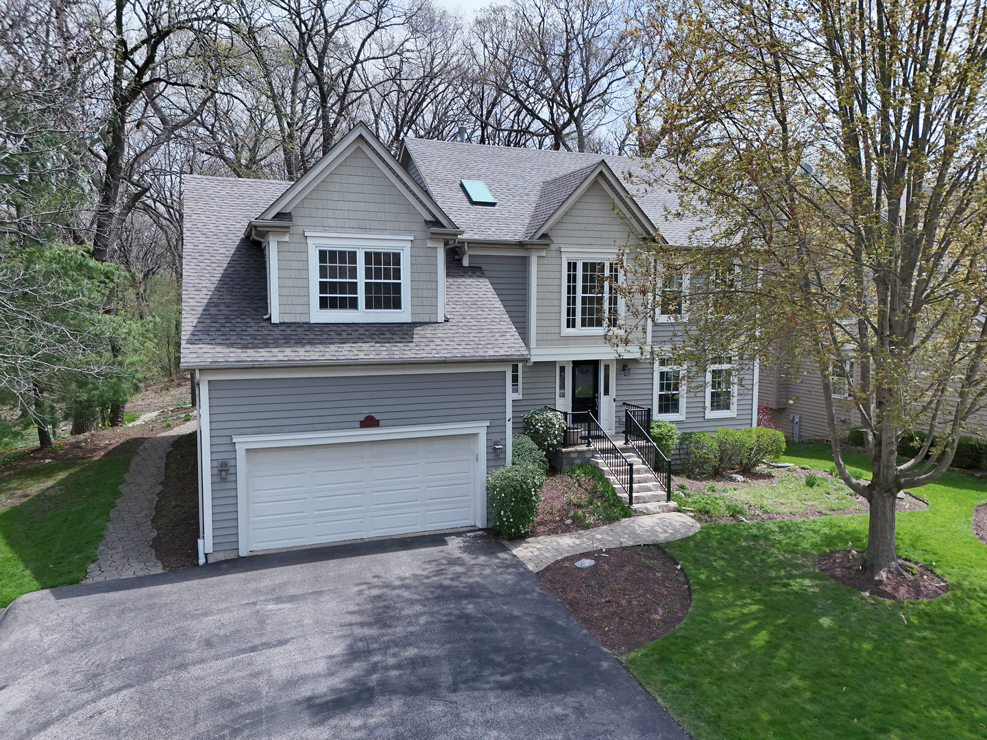718 Barberry Trail Fox River Grove, IL 60021 - Photo 25 of 37 a front view of a house with a yard and garage