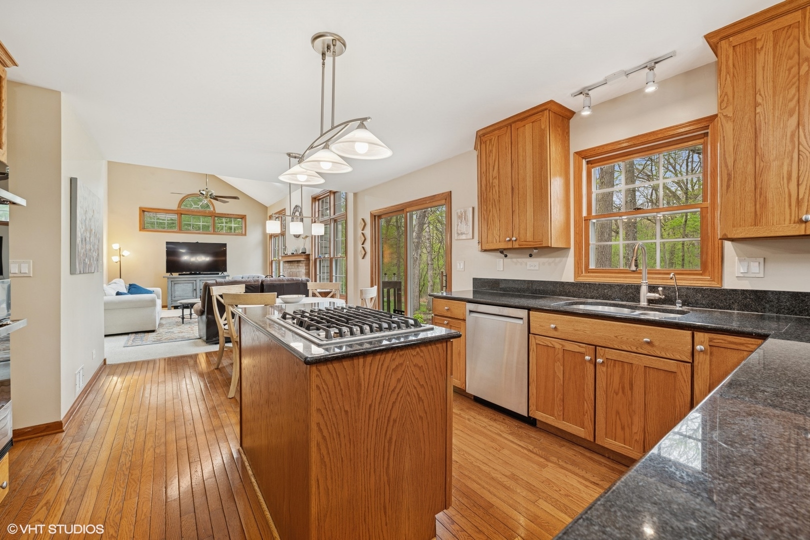 718 Barberry Trail Fox River Grove, IL 60021 - Photo 6 of 37 a kitchen with stainless steel appliances granite countertop a stove top oven a sink dishwasher and wooden cabinets with wooden floor