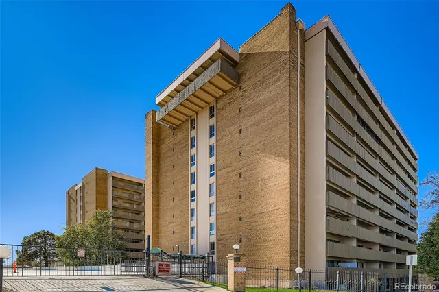 a view of a tall building next to a road