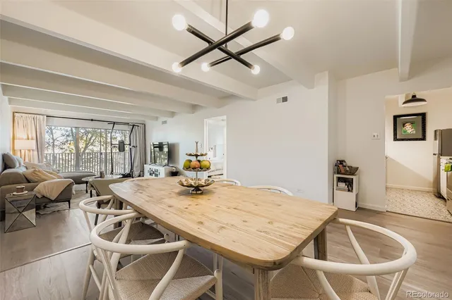 a view of a dining room with furniture and a large window