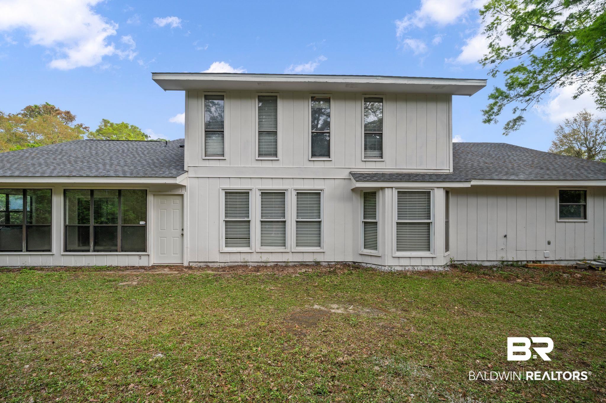 105 South Windgate Circle Daphne, AL 36526 - Photo 36 of 37 Back of property with a shingled roof and a yard