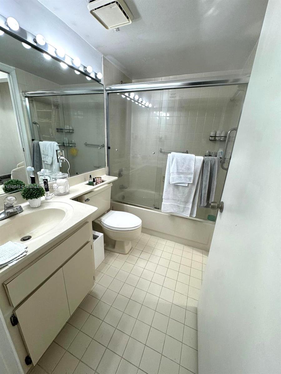 9030 Southwest 125th Avenue, Unit E210 Miami, FL 33186 - Photo 4 of 18 a bathroom with a sink mirror and toilet