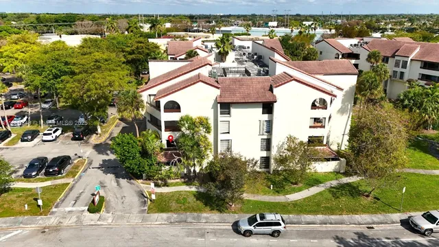an aerial view of a house with a yard and a garage