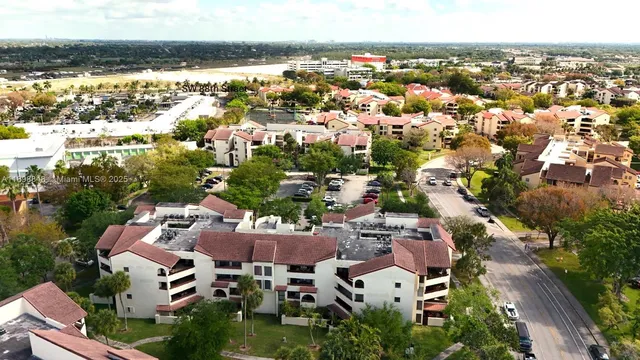 an aerial view of residential houses with city view
