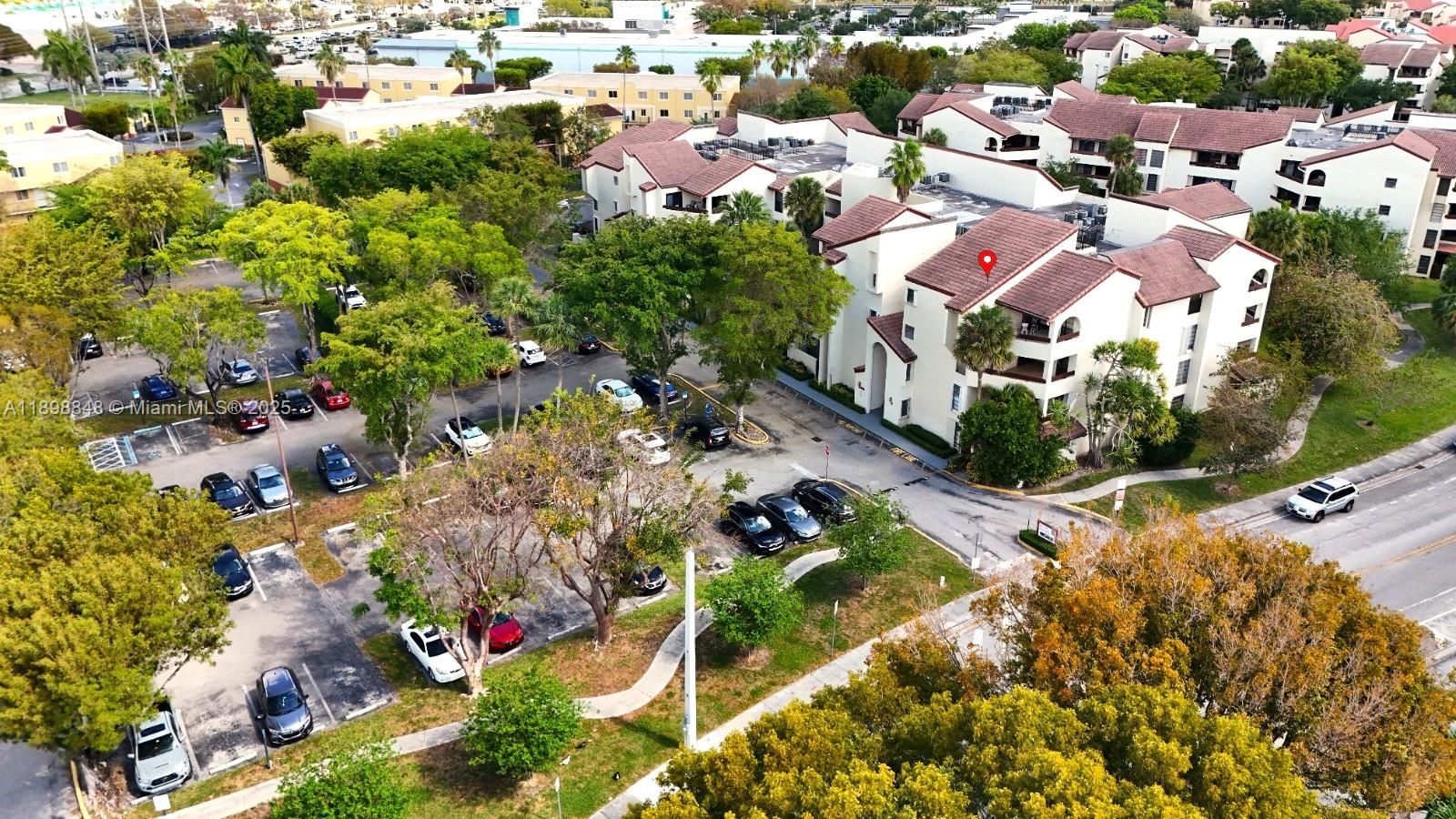 9030 Southwest 125th Avenue, Unit E210 Miami, FL 33186 - Photo 7 of 18 an aerial view of residential houses with outdoor space and trees all around