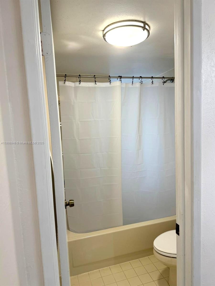 9030 Southwest 125th Avenue, Unit E210 Miami, FL 33186 - Photo 8 of 18 a bathroom with a shower and a toilet