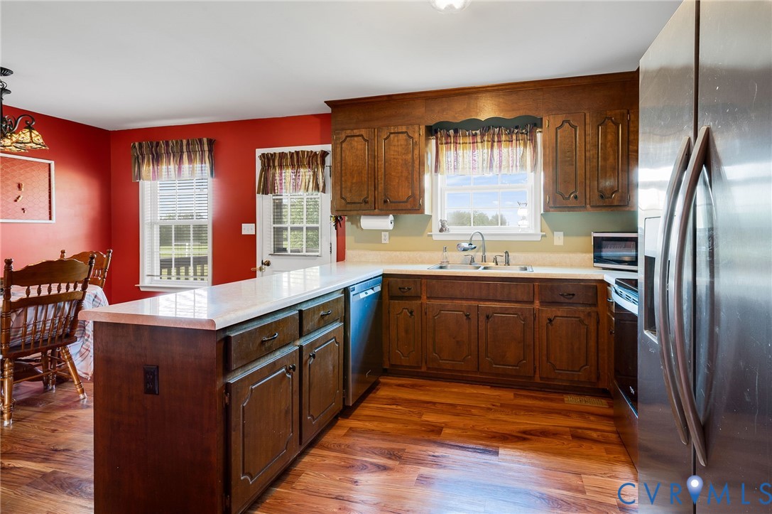 5280 West Quaker Road Disputanta, VA 23875 - Photo 26 of 33 a kitchen with stainless steel appliances granite countertop a sink stove and refrigerator
