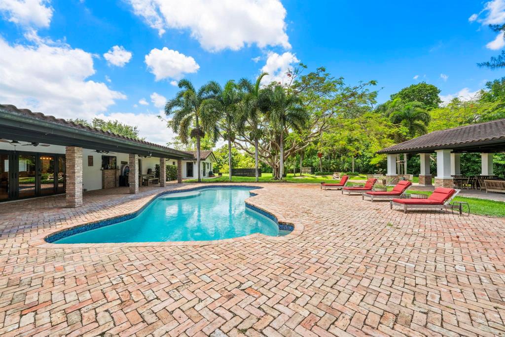 14701 Southwest 63rd Street Southwest Ranches, FL 33330 - Photo 13 of 75 a view of swimming pool with lawn chairs and plants