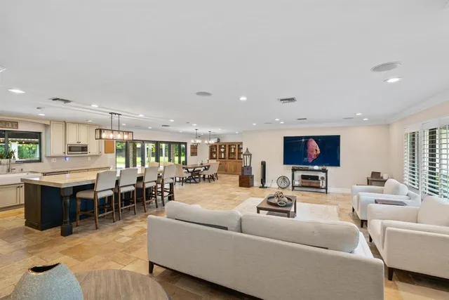 an aerial view of a house with a yard and lake view