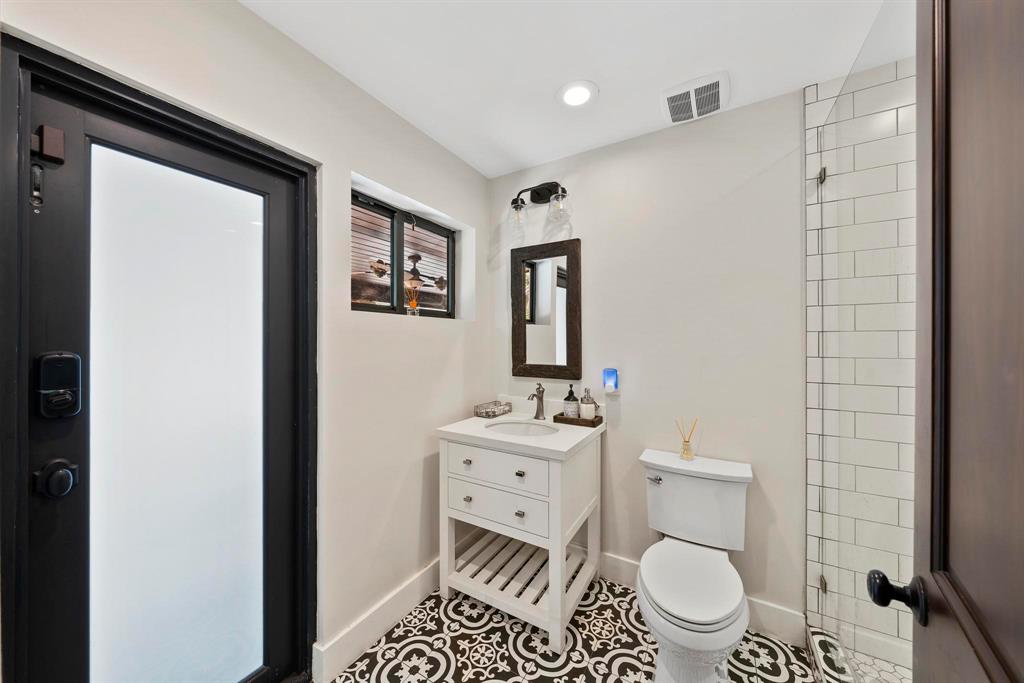 14701 Southwest 63rd Street Southwest Ranches, FL 33330 - Photo 48 of 75 a bathroom with a toilet a sink and a mirror