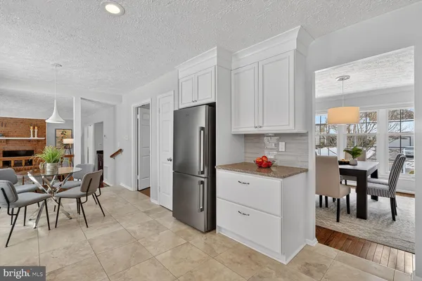 a kitchen with refrigerator and cabinets