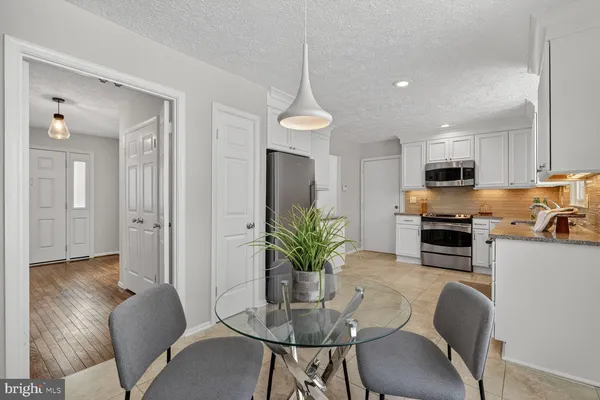 a dining room with furniture and wooden floor