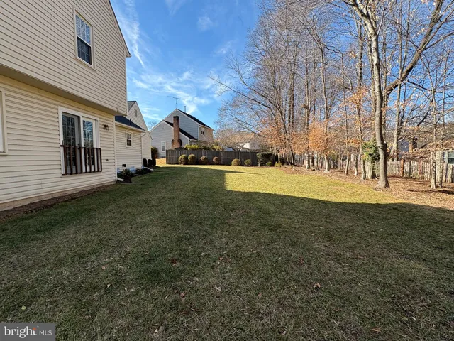 a view of a yard with a house and a tree