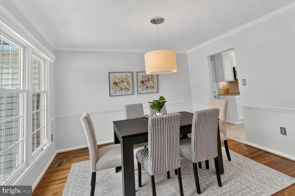 a view of a dining room with furniture and wooden floor
