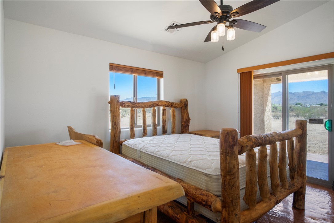 3328 Mobile Road Golden Valley, AZ 86413 - Photo 19 of 46 Bedroom featuring vaulted ceiling, a mountain view, and a ceiling fan