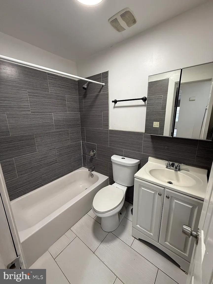 3227 Turner Street, Unit 2 Philadelphia, PA 19121 - Photo 5 of 6 a bathroom with a sink a toilet a mirror and shower