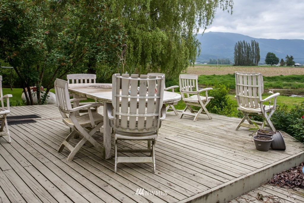 3359 Clearbrook Road Sumas, WA 98295 - Photo 2 of 25 a view of a roof deck with table and chairs and wooden floor