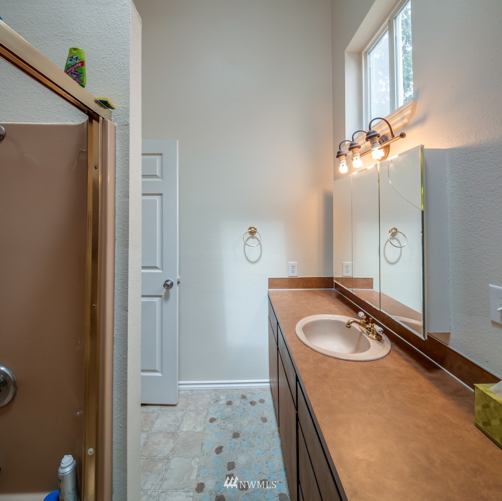 3359 Clearbrook Road Sumas, WA 98295 - Photo 22 of 25 a bathroom with a sink a granite counter and a mirror