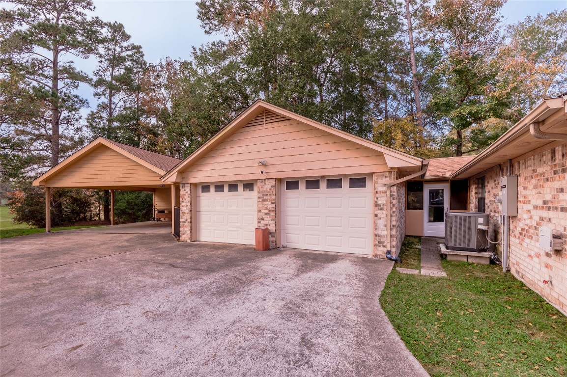1 Cottonwood Trinity, TX 75862 - Photo 22 of 29 a front view of a house with a garden and yard