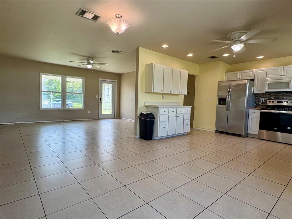 2755 Greendale Road North Port, FL 34287 - Photo 20 of 43 a kitchen with stainless steel appliances kitchen island granite countertop a refrigerator and a stove top oven with a dishwasher