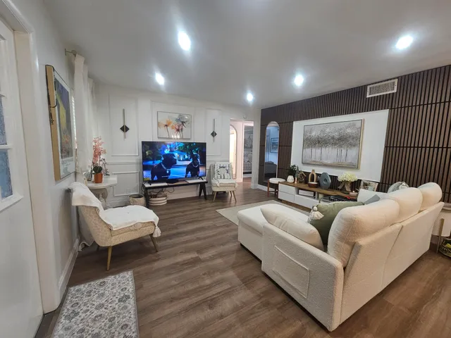 a living room with furniture and a large window