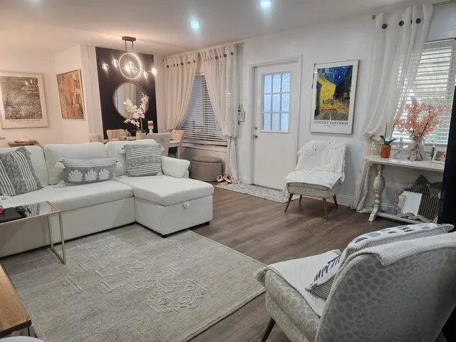 a spacious bedroom with a bed and a flat screen tv