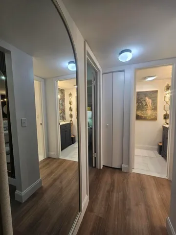 a bathroom with a sink and mirror with toilet