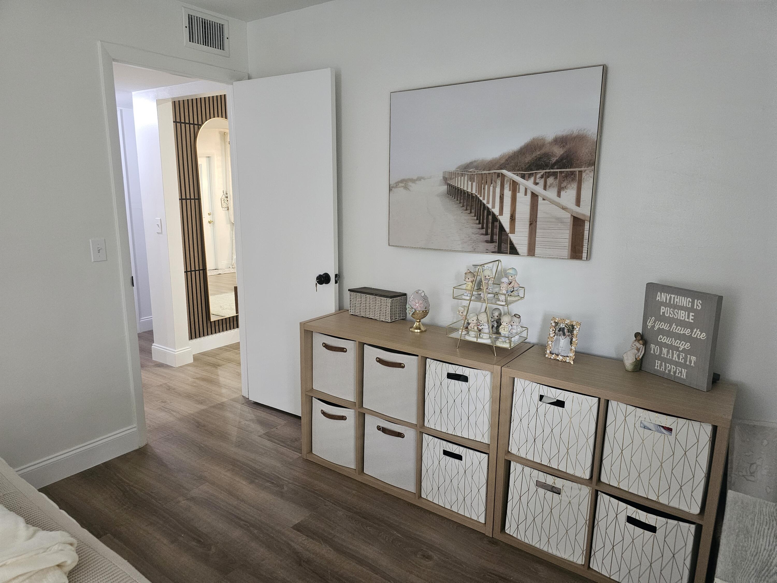 312 Pine Ridge Circle, Unit A2 Greenacres, FL 33463 - Photo 34 of 73 a hallway with white cabinets and wooden floor