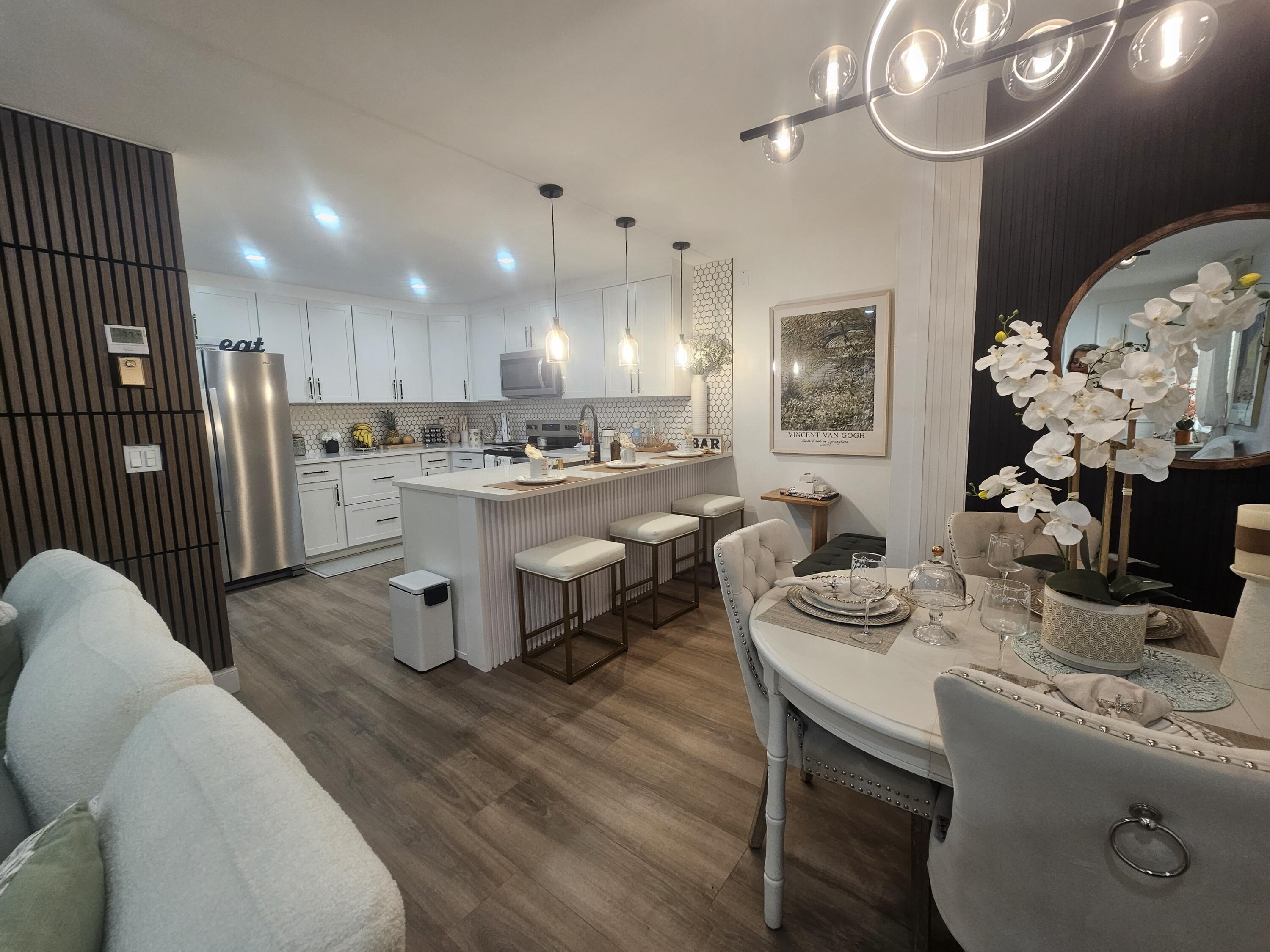 312 Pine Ridge Circle, Unit A2 Greenacres, FL 33463 - Photo 5 of 73 a living room with stainless steel appliances kitchen island granite countertop furniture and a dining room