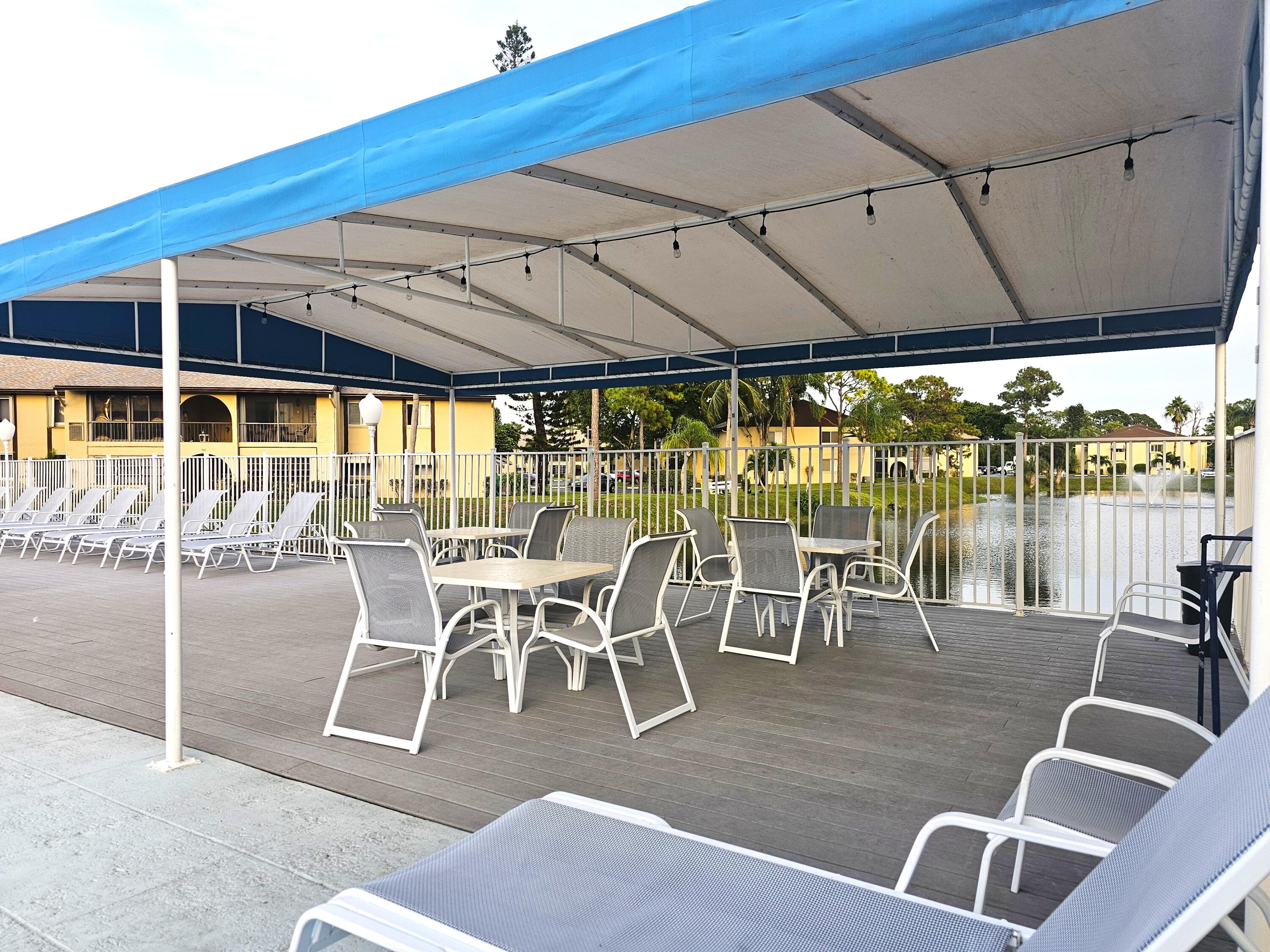 312 Pine Ridge Circle, Unit A2 Greenacres, FL 33463 - Photo 51 of 73 a view of a patio with table and chairs